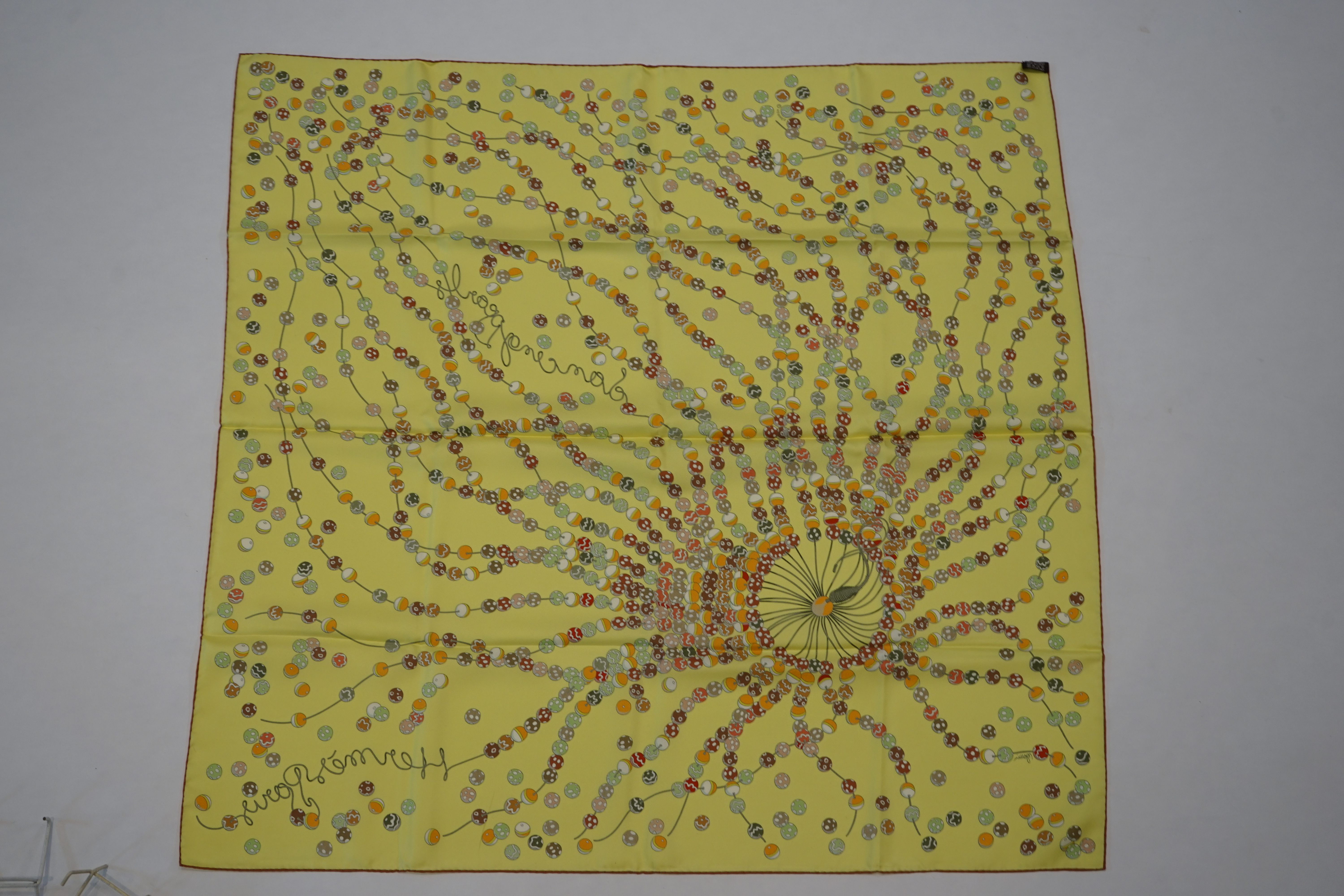 A yellow Hermès 'Dancing Pearls' silk scarf designed by Virginie Jamin, 90cm x 90cm